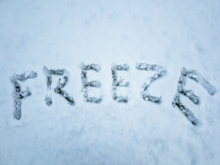 FREEZE written in the freshly fallen snow