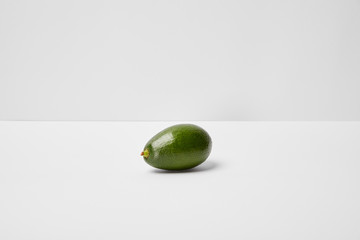 selective focus of whole avocado on grey background