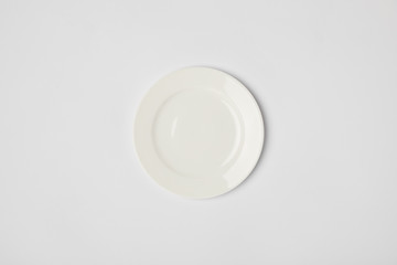 top view of porcelain plate on grey background