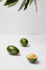 selective focus of avocados on grey background
