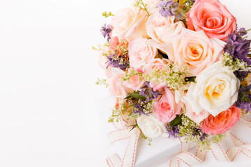 Luxury bouquet made of red roses in flower shop and white ribbon on wooden board. Overhead top view, flat lay. Copy space.