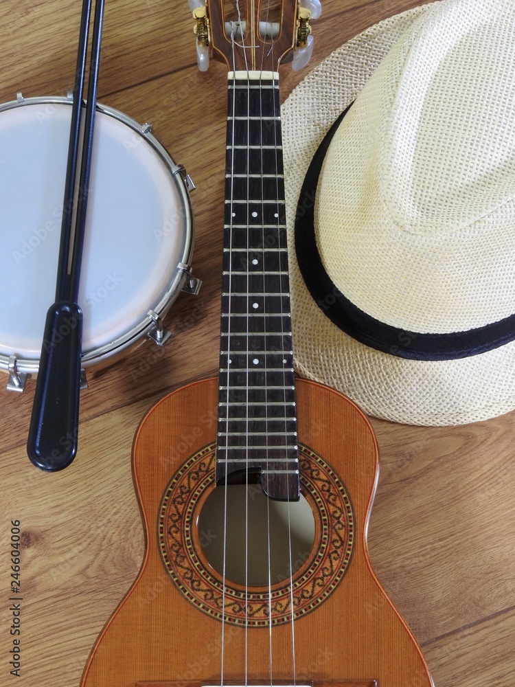 Wall mural A samba player (sambista) hat and two Brazilian musical instruments: cavaquinho and tamborim with drumstick. The instruments are widely used to accompany samba, a popular Brazilian rhythm.