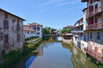 Fototapeta na wymiar River Nive at Saint-Jean-Pied-de-Port, a commune in the Pyrénées-Atlantiques department in south-western France close to Ostabat in the Pyrenean foothills