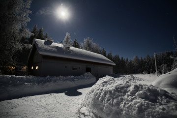 Swedish barn in clear winter night with bright moon