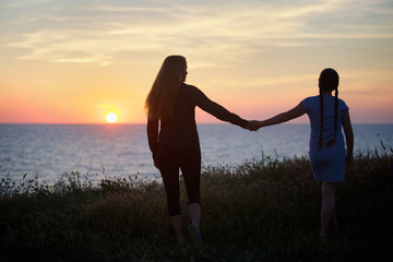 Silhouette of beautiful slim mum with daughter