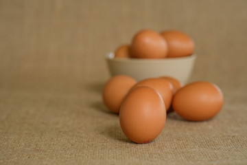 A dozen of eggs shot with gunny sacks as background.