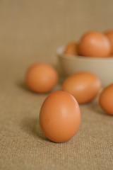A dozen of eggs shot with gunny sacks as background.