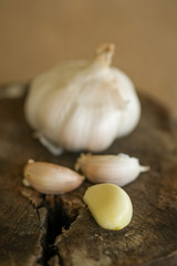 Garlics shot with wooden planks as background.