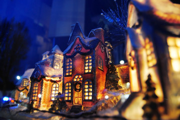 Christmas led light up village scene in storefront.