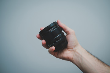 Fototapeta premium Camera lens in hand