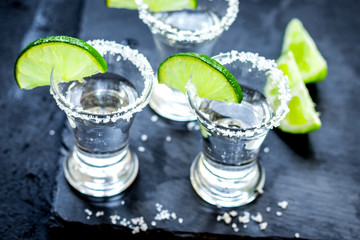 Set for tequila party with lime and salt on black background