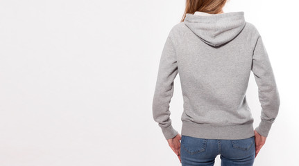 Shirt design and fashion concept - young woman in gray sweatshirt, gray hoodies, blank isolated on white background