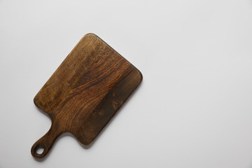 top view of wooden cutting board on grey background