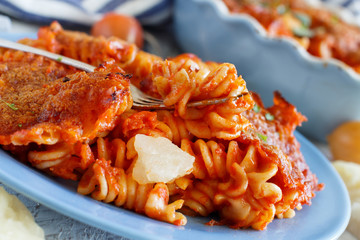 Baked pasta with tomato sauce and mozzarella cheese