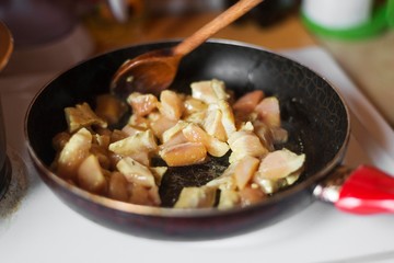 chicken meat cooking in pan.