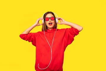cool young girl with red hoodie listening music