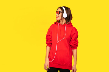 cool young girl with red hoodie listening music