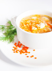 Bowl with lentil soup on white