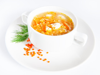 Bowl with lentil soup on white