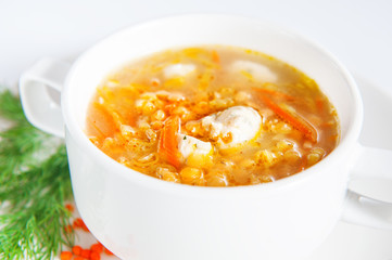 Bowl with lentil soup on white
