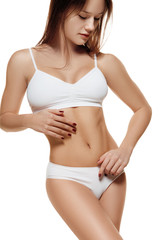 Fototapeta premium Perfect slim toned young body of the girl or fit woman at studio. The fitness, diet, sports, plastic surgery and aesthetic cosmetology concept. Image is not body shape retouched