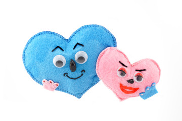 small soft homemade toy in the form of a heart for Valentine's Day on a white isolated background