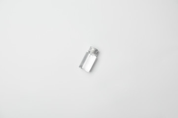 Top view of transparent cometic bottle on white background with copy space