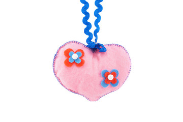 small soft homemade toy in the form of a heart for Valentine's Day on a white isolated background