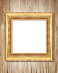 The antique gold frame on wooden wall background