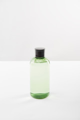Cosmetic bottle with lotion on white background with copy space