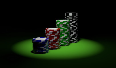 four stacks of poker chips in spotlight