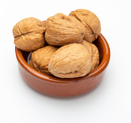 Walnuts in clay bowl (Various nuts collection). Isolated on white background.