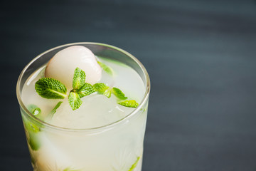 Fresh lychee mojito on the rustic background. Selective focus. Shallow depth of field. 