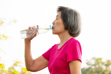 Senior woman drinking water.