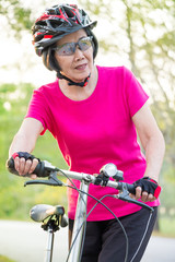 Naklejka premium Senior woman and bicycle