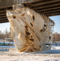 Bridge across Volga river, winter, repairing
