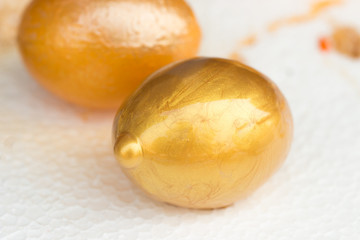 Happy easter day concept : Gold color composition egg on colored white background, Easter is festival and holiday celebrating resurrection of Jesus from dead. Space for text
