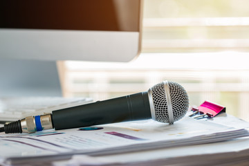 Microphone on paper document at seminar with graphical interface. communication technology for...