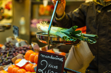 Vendor putting vegetables on a scale