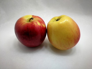two colored apples on white