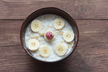 oatmeal with fruit and berries on wooden background