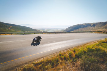 Wide angle view of an adventure bike rider enjoying the open road in the western cape of south...