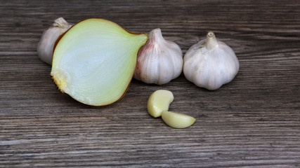 garlic and onion on wooden table