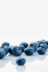 Fresh organic blueberries on a marble background, close up with copy space