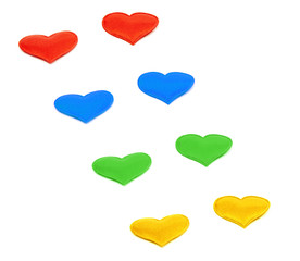 Colored hearts diagonally on an isolated background, wallpaper or texture