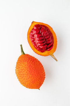 Gac fruit on a white background, creative flat lay food concept