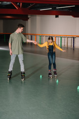 Handsome young trainer giving instructions to attractive child