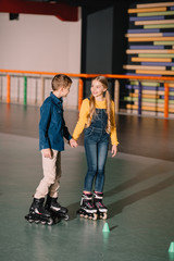 Beautiful smiling skating and holding hands