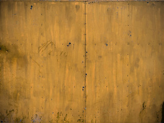 metal wall painted in yellow color background, background texture of old vintage yellow metal door,colorful abstract painting on metal board background, retro style of old metal rust wall with peeling