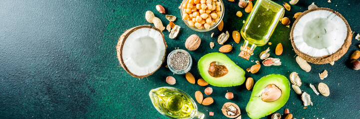 Healthy vegan fat food sources, omega3, omega6 ingredients - almond, pecan, hazelnuts, walnuts, olive oil, chia seeds, avocado, coconut,  banner copy space - obrazy, fototapety, plakaty